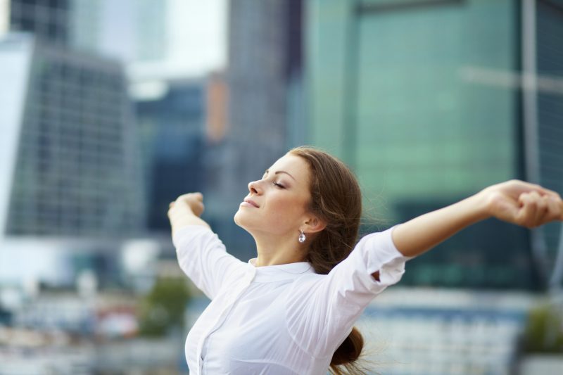 Successful business woman with arms outstretched